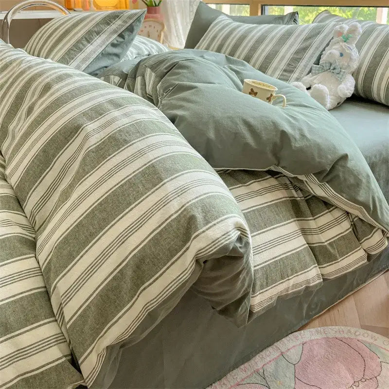 Olive and cream cotton striped bedding set featuring a cozy sage green and cream duvet with textured fabric finish