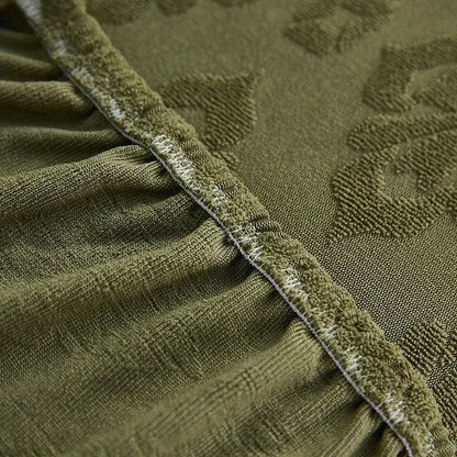 Olive green patterned jacquard sofa seat cover with textured leaf design and frayed white-trimmed edge for living room protector