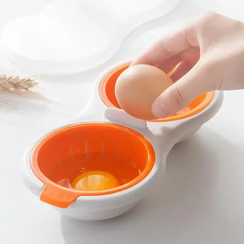 Orange and white egg boiler steamer double cup with built-in strainer for easy yolk separation and egg boiling