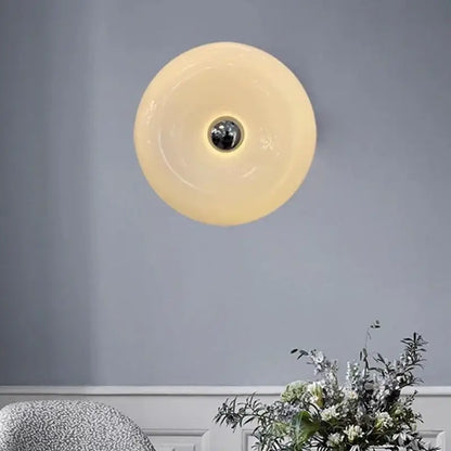 Cream-colored translucent glass donut led wall sconce with polished chrome center for bedroom lighting decorbites wall sconce