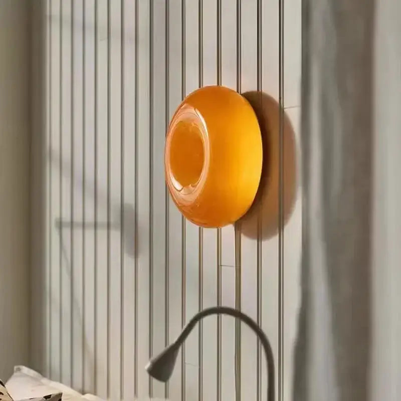 Vibrant orange translucent silicone soap dish with smooth rounded design complementing decorbites glass donut led wall sconce
