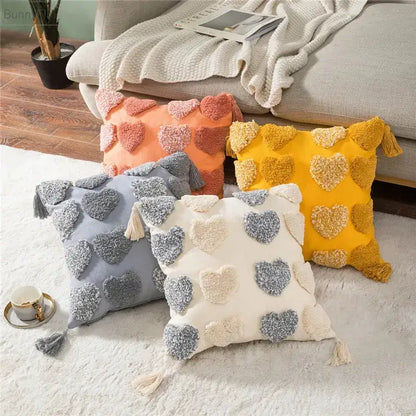Four cozy orange and grey heart embroidery cushion covers with tassels and pom-pom hearts for living room decorbites