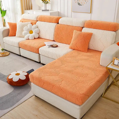 Orange quilted fabric sofa cover with white textured back cushions featuring a leaf jacquard pattern for living room protection