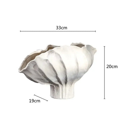 A white ceramic wavy flower vase with fluted leaf-like rim and textured surface for living room decorbites ceramic wavy decor