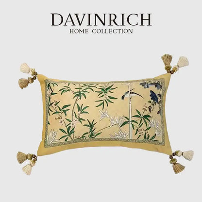 A rectangular beige orchid velvet lumbar pillow cover with embroidered green bamboo leaves and blue birds from davinrich home