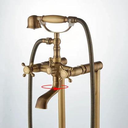 Ornate antique brass freestanding bathtub filler with clawfoot tub faucet cross handles and flexible shower hose