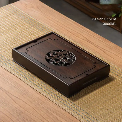 Dark brown wooden tea tray with intricate carved floral design for ornate black bamboo tea tray drainage use