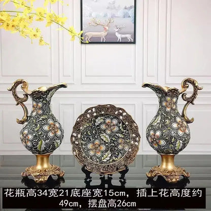 Pair of ornate black and gold resin vase dried flowers with floral patterns and golden handles for living room decor