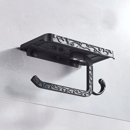 Ornate black metal toilet paper holder with intricate scrollwork design and phone shelf for bathroom storage