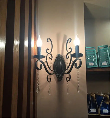 Ornate black wrought iron wall lamp with two candle-style lights and crystal droplets for living room decorbites black wrought