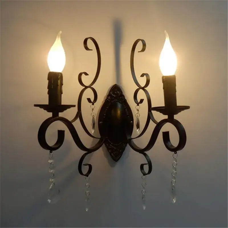 Ornate black wrought iron wall lamp with dark bronze scrollwork and crystal accents for elegant living room decorbites black wrought