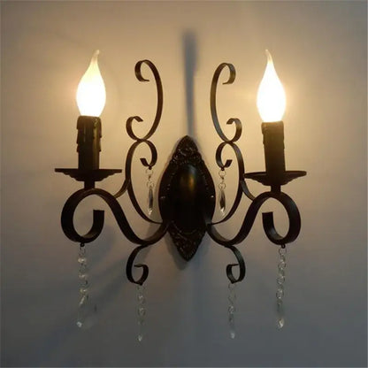 Ornate black wrought iron wall lamp with dark bronze scrollwork and crystal accents for elegant living room decorbites black wrought