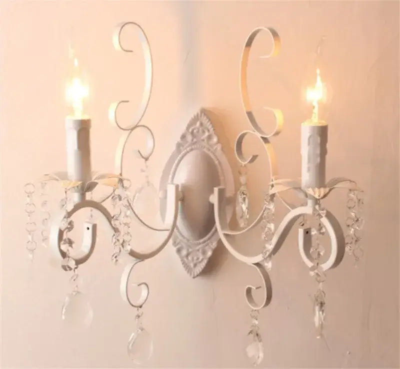 White wrought iron wall lamp with ornate scrollwork and crystal droplets perfect for decorbites black wrought iron decor