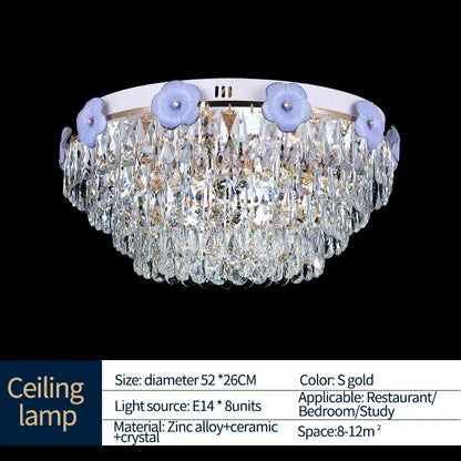 Ornate blue and gold decorbites crystal candle chandelier with circular white base and light purple floral accents for staircase lighting