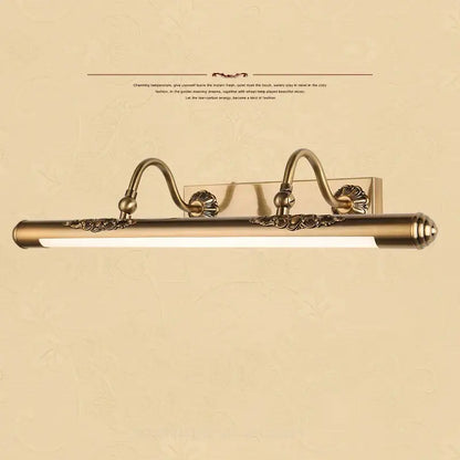 Antique brass-finished bathroom mirror lamp with ornate scrollwork and sleek elongated led bar for vanity lighting