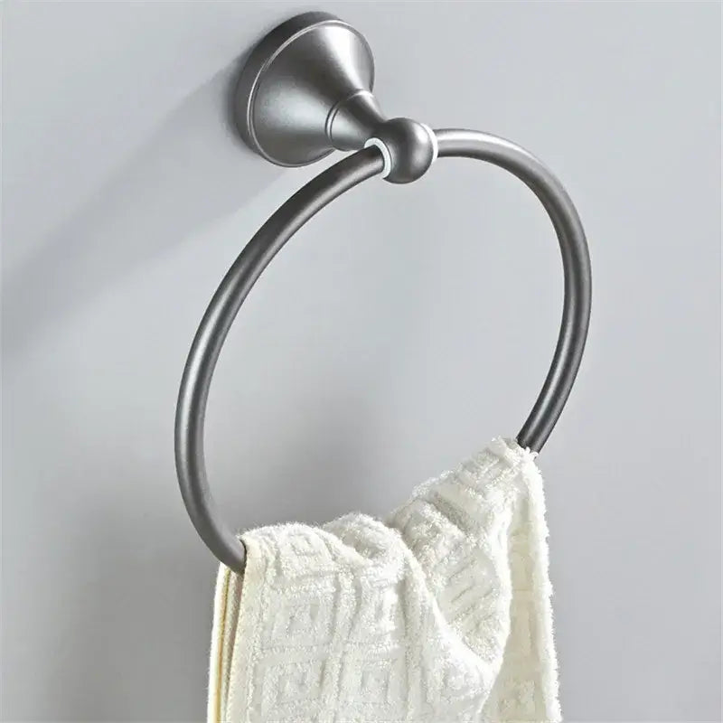 Ornate brushed nickel towel ring with sleek circular design holding white towel in gray bathroom accessories set decorbites gray bathroom