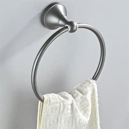 Ornate brushed nickel towel ring with sleek circular design holding white towel in gray bathroom accessories set decorbites gray bathroom