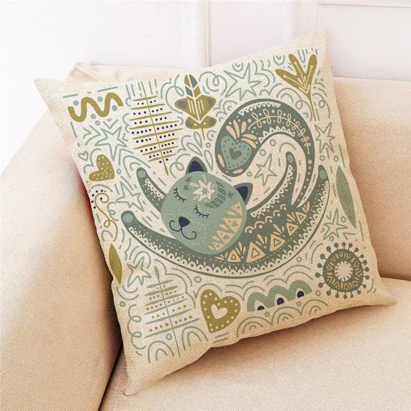 Beige linen throw pillow with decorbites cat design featuring a sleeping green cat and botanical patterns in muted tones