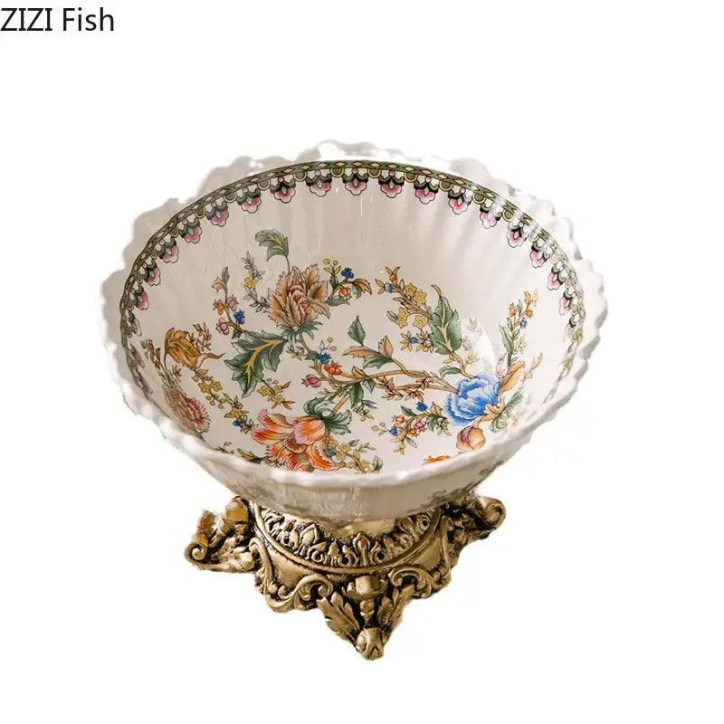 Ornate ceramic flower pattern fruit bowl with colorful flower pattern in pastel hues on a gold-toned metal stand