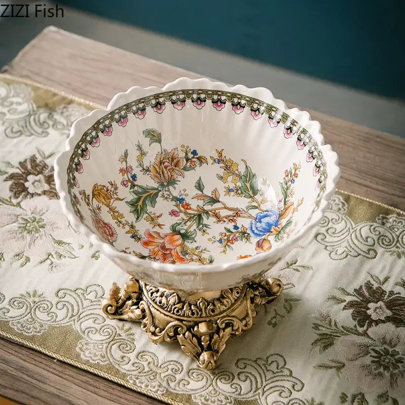 Ornate white ceramic pattern fruit bowl with colorful flower pattern on gold metal stand for dining room use