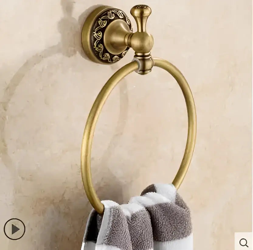 Antique brass towel ring with ornate carved mounting plate in ornate gold copper carved bathroom accessories set