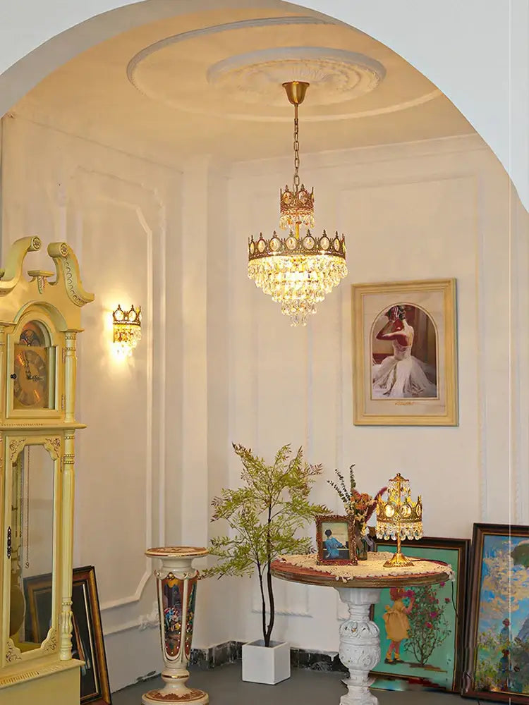 A gold ornate crown crystal led pendant light with crystal droplets for living room decorbites pendant light