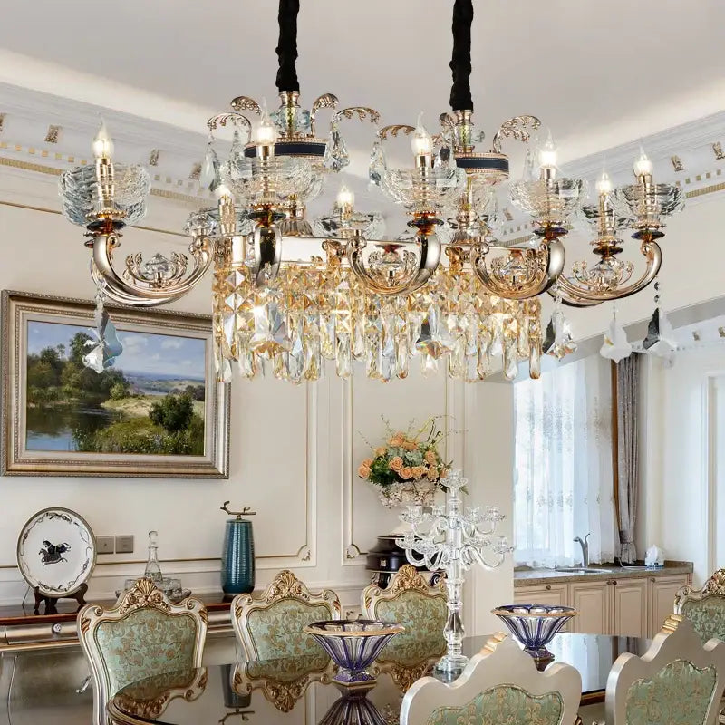 Ornate gold crystal candle chandelier with multiple arms hanging from black cords above dining room table decorbites crystal candle