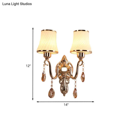 Ornate gold crystal wall sconce with two cream fabric shades and amber teardrop crystals for e26 e27 bulb base lighting