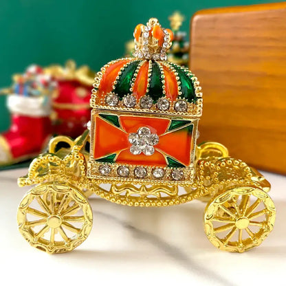 Ornate gold enamel crown jewelry box carriage with vibrant orange and green enamel accents for bedroom decor