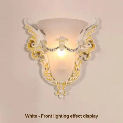 Elegant white and gold ornate glass sconce light with crystal embellishments designed as a wall lamp for living room use