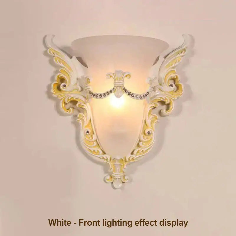 Elegant white and gold ornate glass sconce light with crystal embellishments designed as a wall lamp for living room use