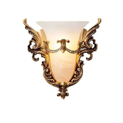 Ornate gold-toned glass sconce light with crystals and amber shade designed as a wall lamp for living room use