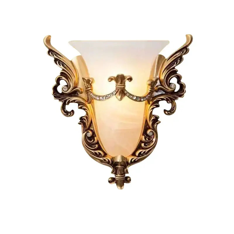 Ornate gold-toned glass sconce light with crystals and amber shade designed as a wall lamp for living room use
