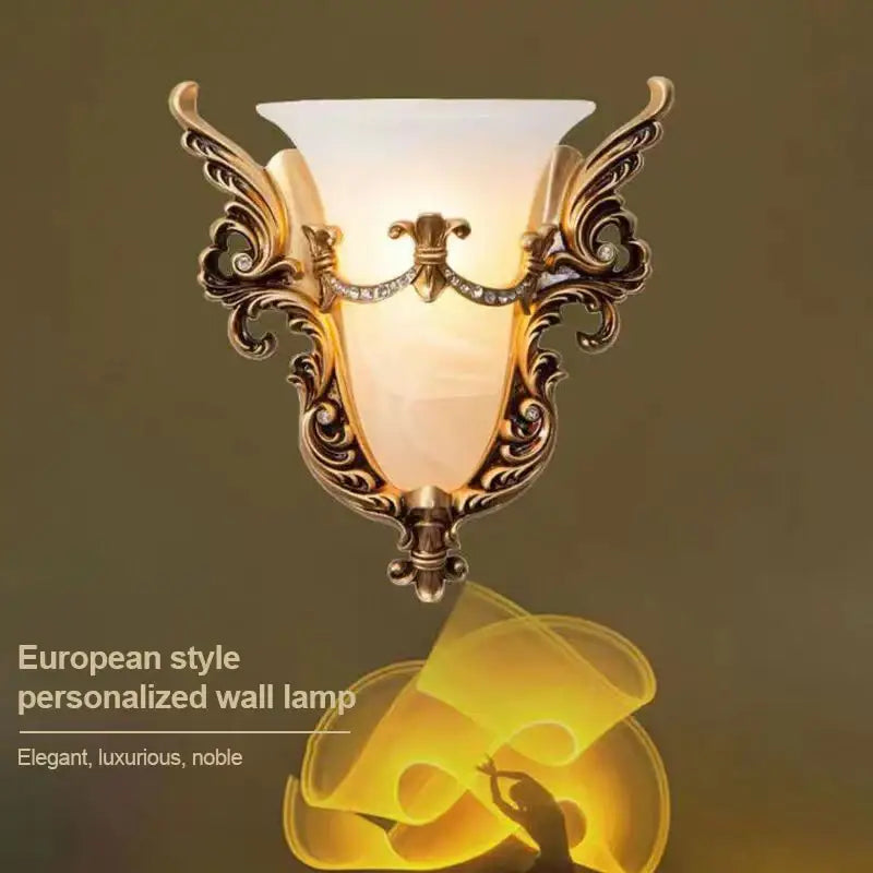 Ornate gold-toned wall lamp with frosted glass sconce light and decorative crystal accents for living room use