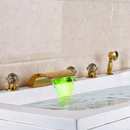 Ornate gold bath tub faucet with translucent green acrylic waterfall spout and crystal handles for bathroom use