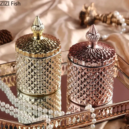 Two ornate faceted glass storage jars with gold and rose gold lids sit on a mirrored tray for bedroom decor