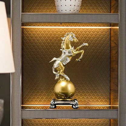 Ornate decorbites golden horse sculpture in gold and silver standing on a polished gold sphere with a black base