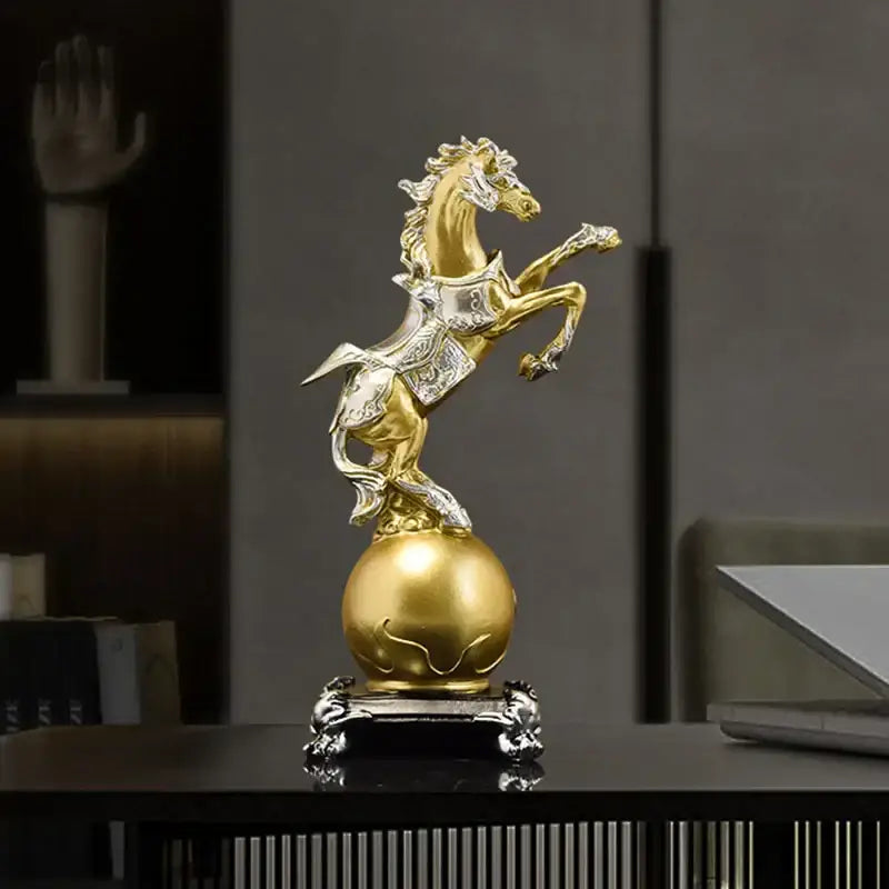 Ornate decorbites golden horse sculpture in gold and silver standing on a polished gold sphere with an intricate base