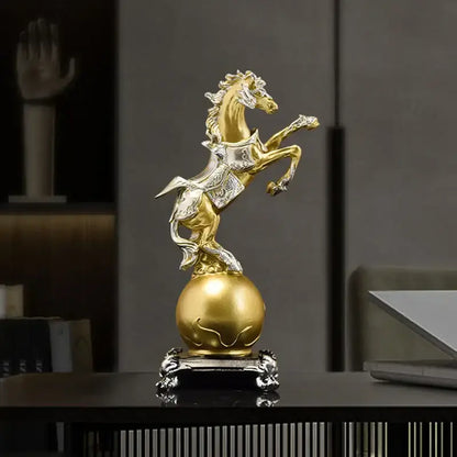 Ornate decorbites golden horse sculpture in gold and silver standing on a polished gold sphere with an intricate base