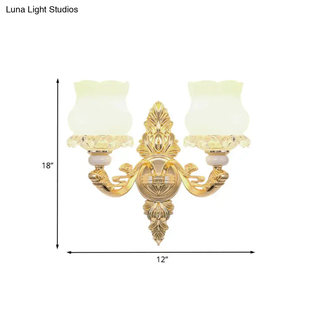 Ornate gold wall light fixture with two frosted glass bloom shades ideal for living room fixture width