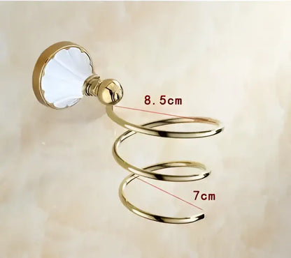 Gold-colored spiral towel rack with white ceramic base from ornate gold and white ceramic decorbites bathroom accessories set