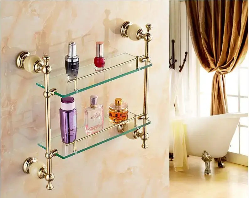 Ornate brass-finished double-tier glass shelf with decorative knobs in decorbites brass jade bathroom hardware set