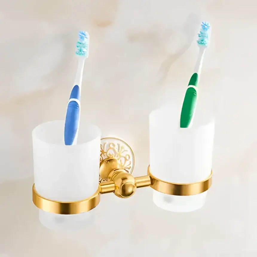 Gold-toned double toothbrush holder with frosted white cups in ornate gold and white floral decorbites bathroom accessories set