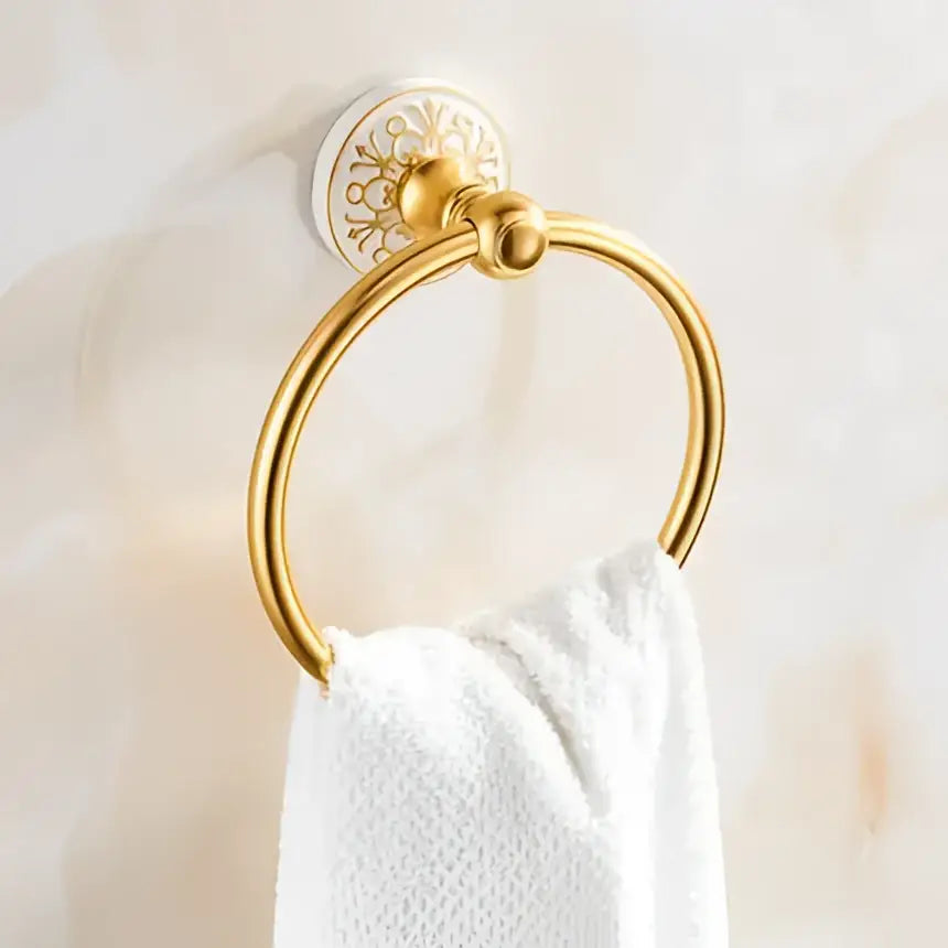 Ornate gold-toned towel ring with circular design and decorative backplate in decorbites bathroom accessories set
