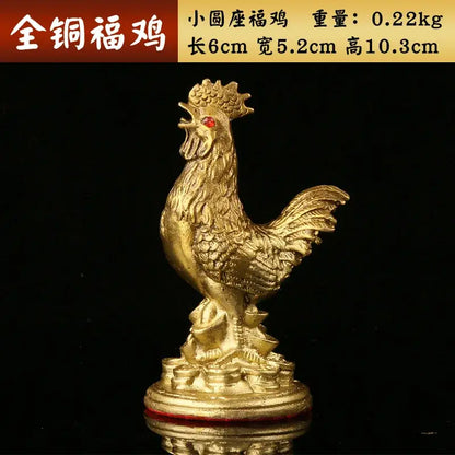 Ornate golden brass rooster figurine with red gemstone eye on a coin-adorned base for office decorbites brass rooster decor