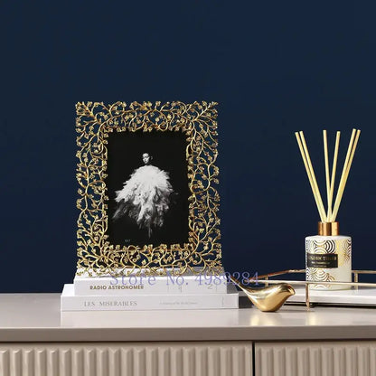 Ornate golden leaves metal photo frame with intricate leaf and vine detailing holding a black and white portrait decorbites golden leaves