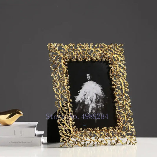 Ornate golden leaves metal photo frame with intricate leaf and vine detailing for living room decor by decorbites