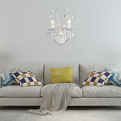 Ornate silver wall light fixture featuring a delicate white crystal chandelier with curved arms and teardrop crystals