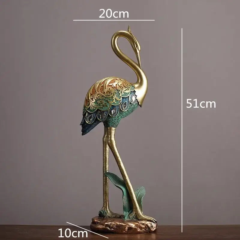 Ornate teal and gold crane bird sculpture with intricate feather patterns standing on a textured base for living room decor