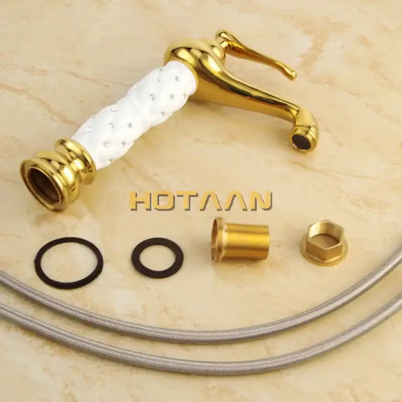 Ornate white and gold brass basin faucet with textured ceramic handle and embedded crystals decorbites basin faucet